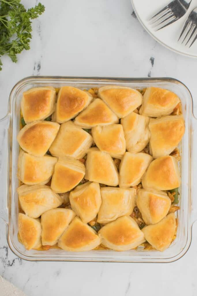 A baked biscuit topped chicken pot pie in a square baking dish.