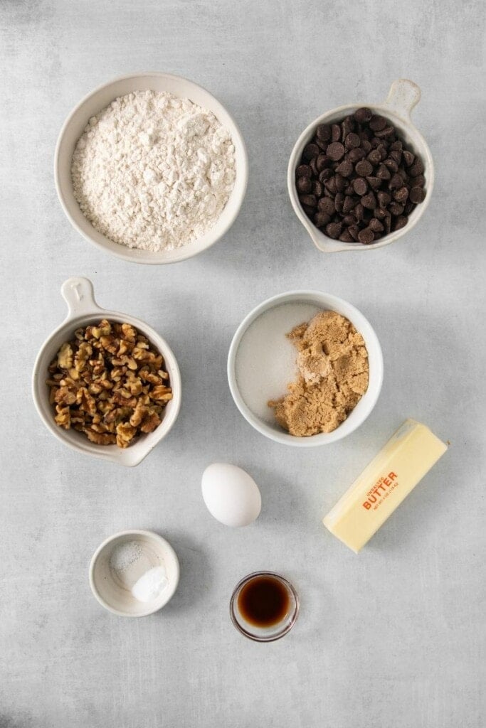 Ingredients needed to prepare walnut chocolate chip cookies.