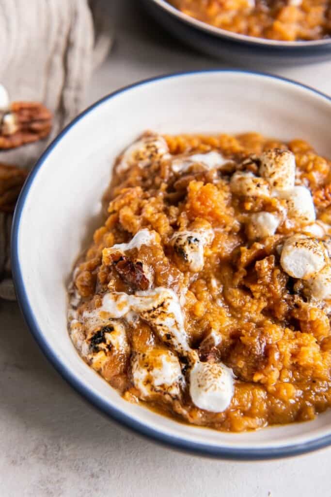 Sweet Potato Casserole topped with marshmallows in a serving bowl.