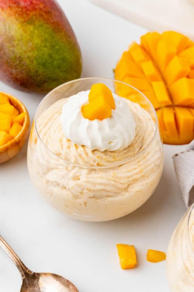 A single serving of mango mousse in a dessert dish.