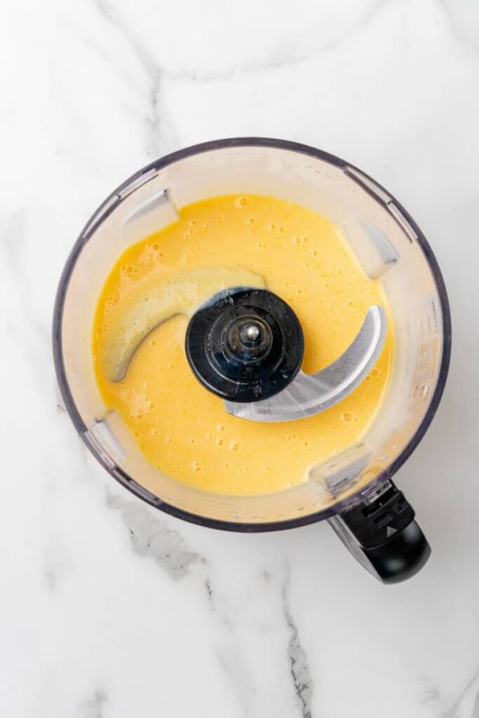 Using a food processor to smooth out mango gelatin mixture.