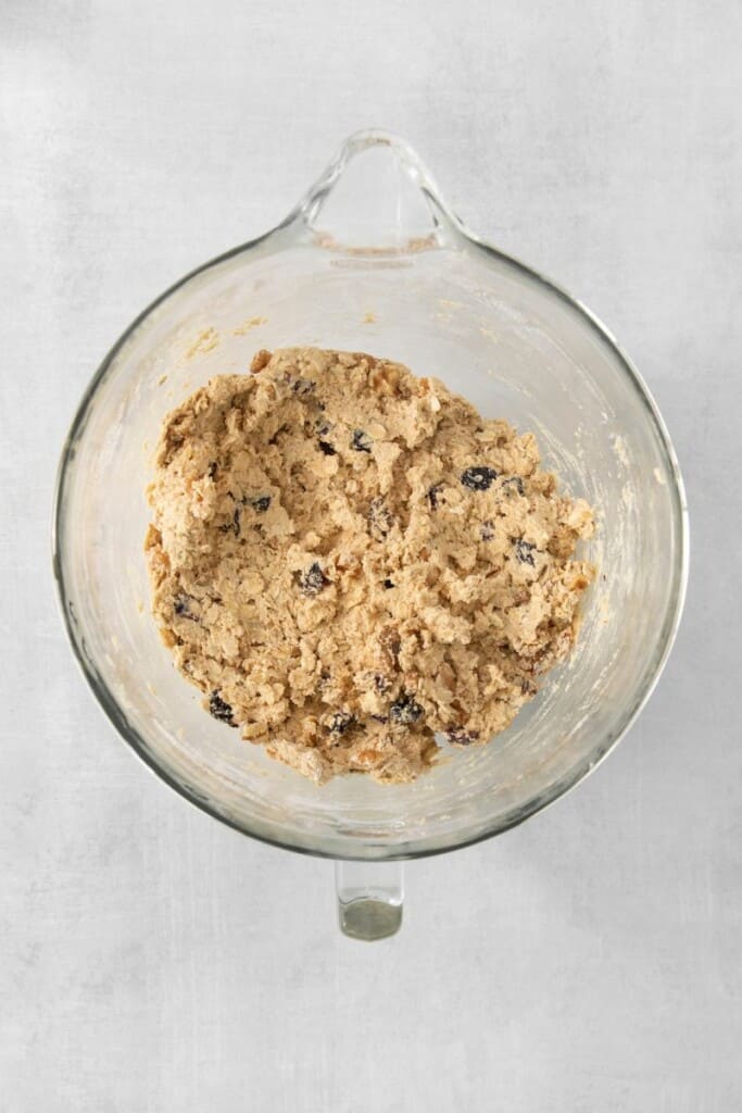 Adding cranberries and walnuts to cookie batter.