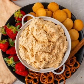 overhead shot of pumpkin dip with cool whip served with fruits and cookies