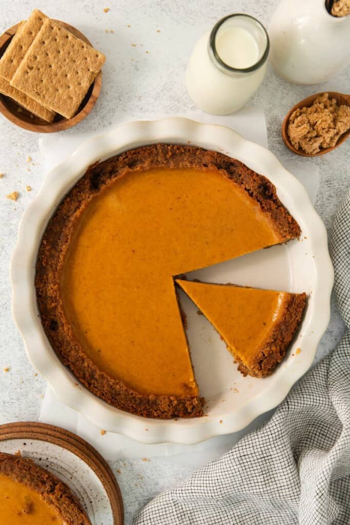 Baked sweet potato pie with slices removed.