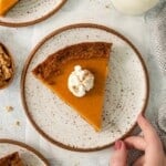 An overhead view of sweet potato pie topped with whipped cream.