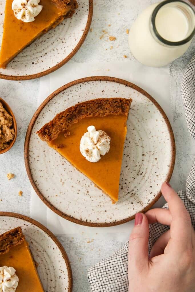 An overhead view of sweet potato pie topped with whipped cream.