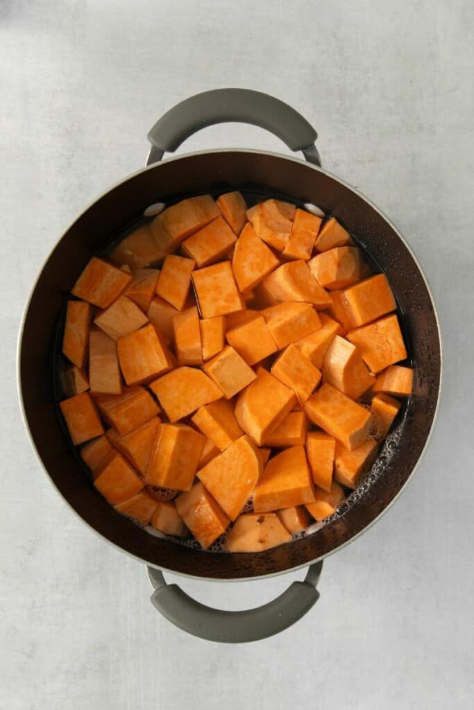 Sweet potatoes cut into cubes and placed into a stockpot.