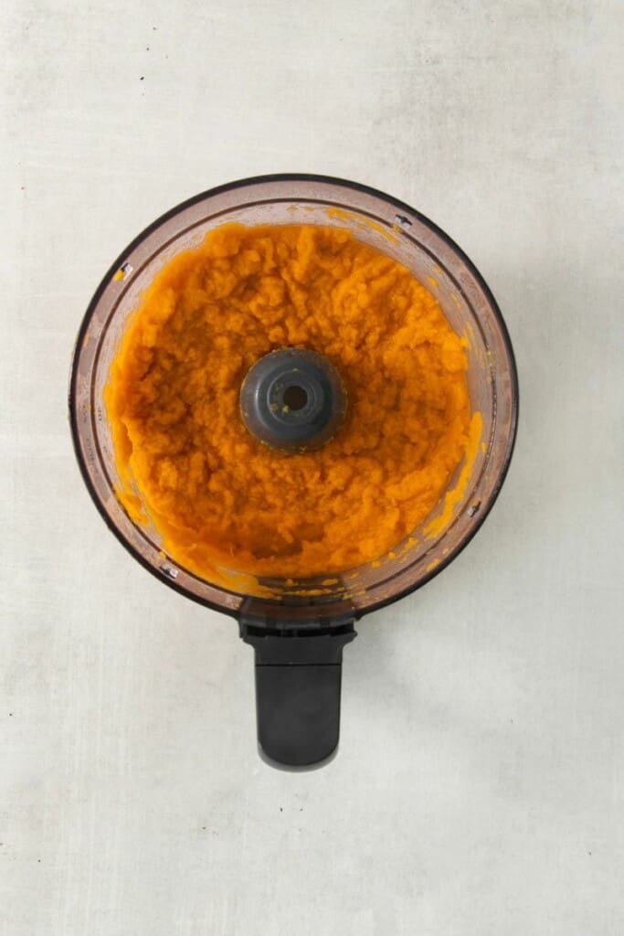 Cooked sweet potatoes in a food processor.