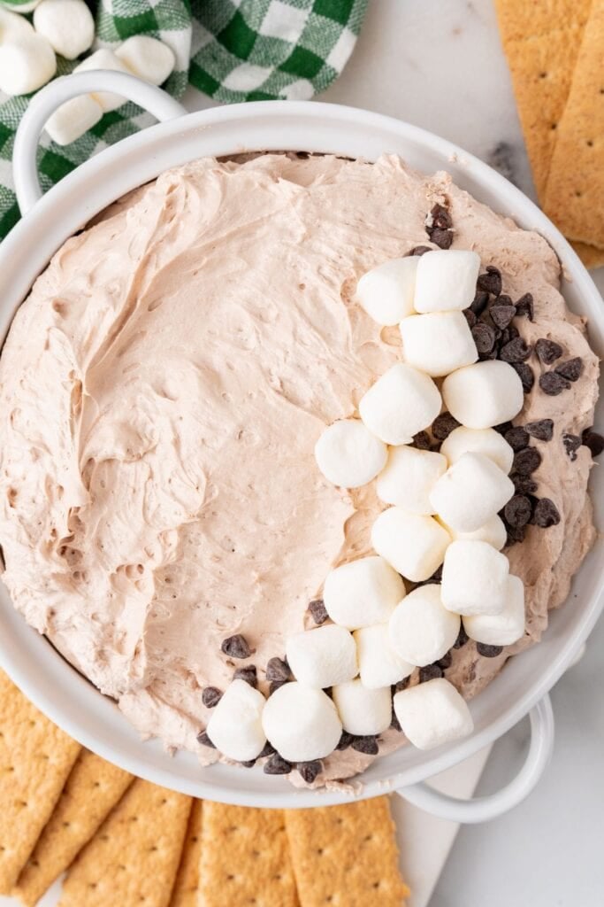 Close up overhead view of the hot cocoa dip recipe topped with marshmallows and mini chocolate chips.