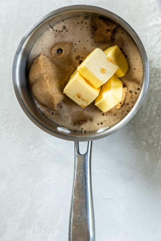 adding butter, brown sugar and root beer in a pot. 