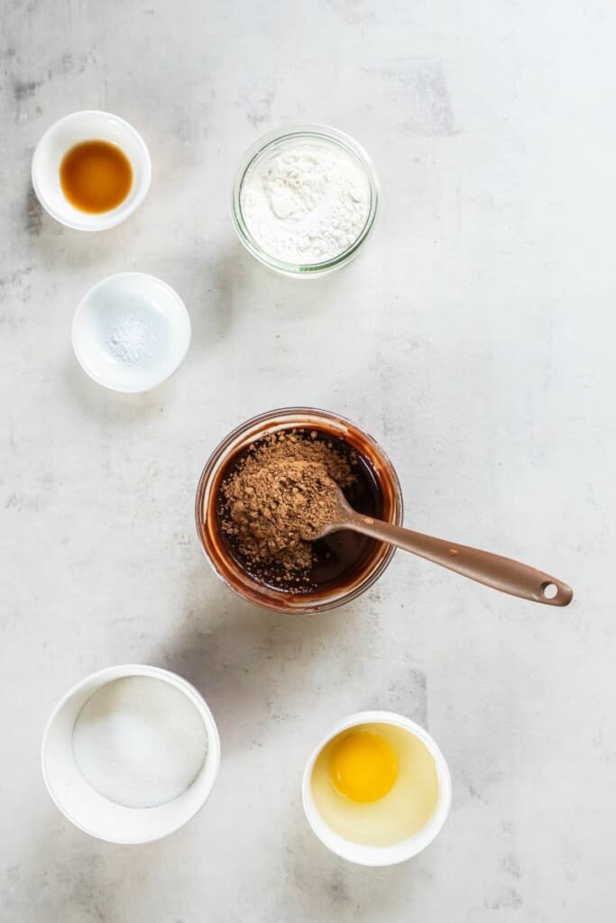 whisking in cocoa powder into melted chocolate