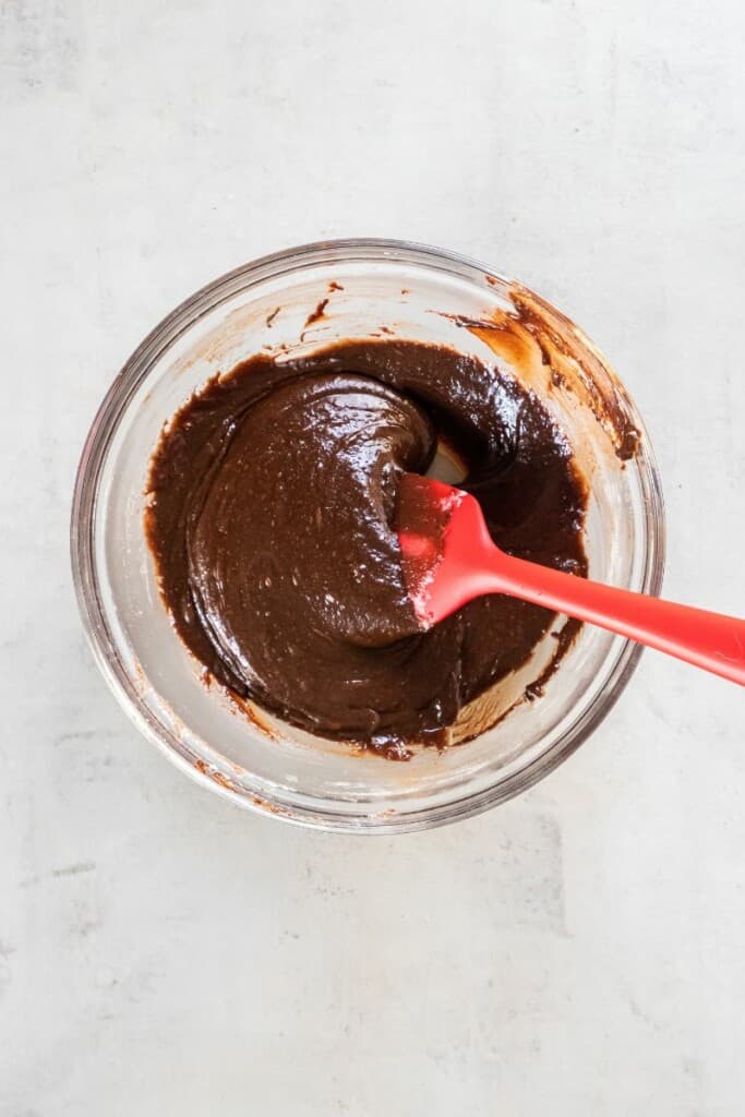 adding flour to brownie batter.
