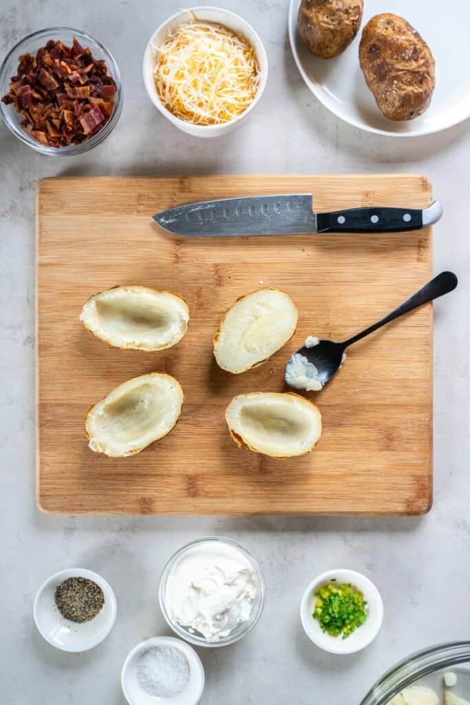 slicing cooked potatoes and scooping out the middle. 