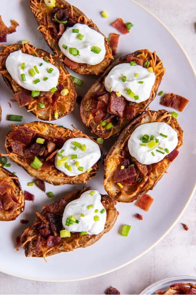 air fryer potato skins with bacon, sour cream and green onions. 