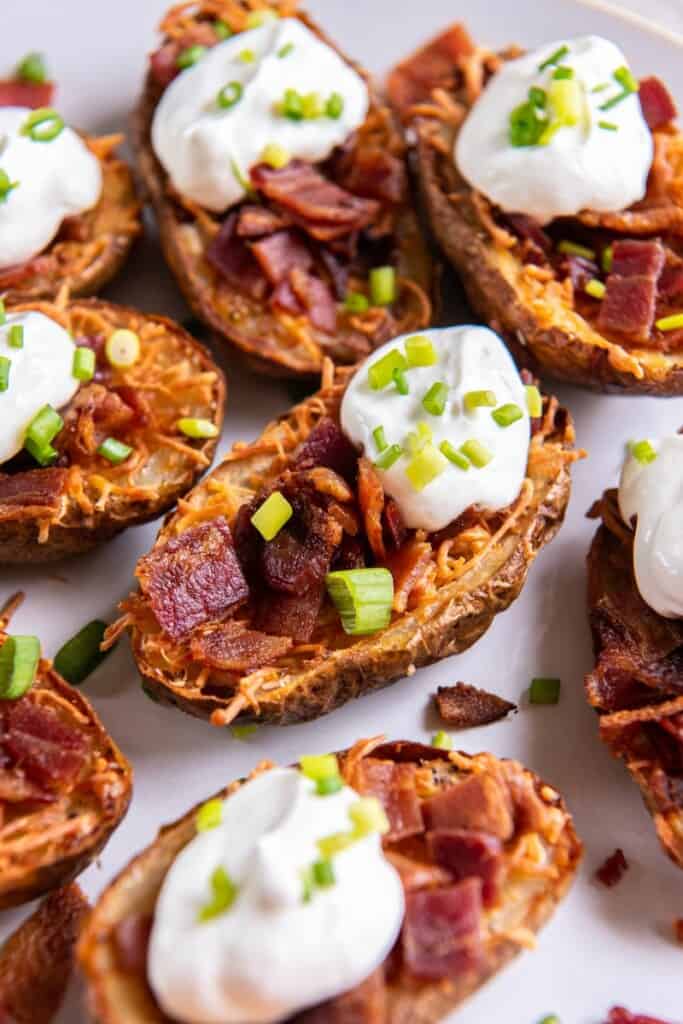 close up of loaded potato skins in air fryer. 
