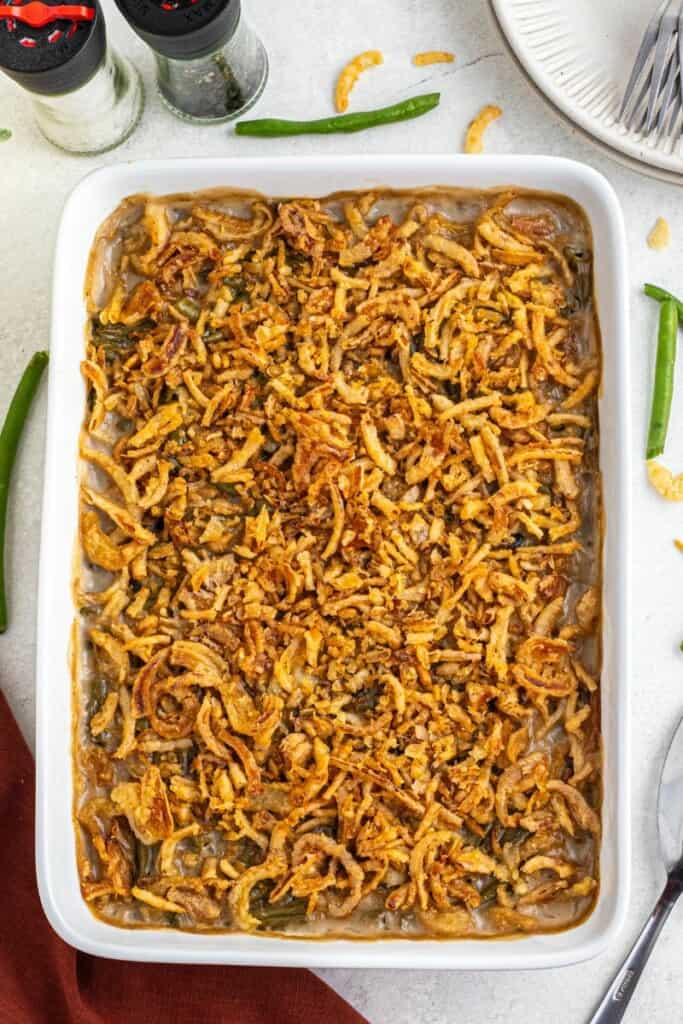 green bean casserole made with canned green beans in a white casserole dish with golden brown fried onions