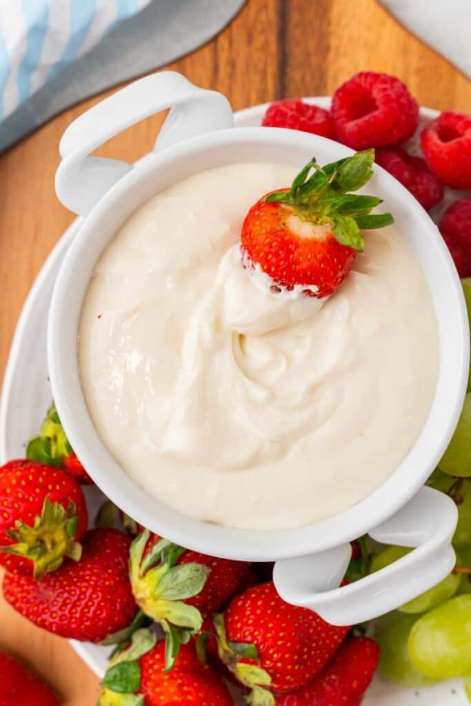 dipping fruit into a cream cheese dip. 