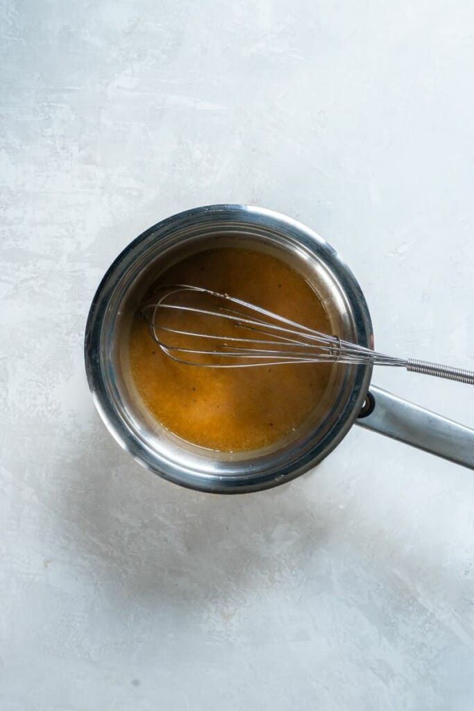 whisking together ham drippings with butter. 