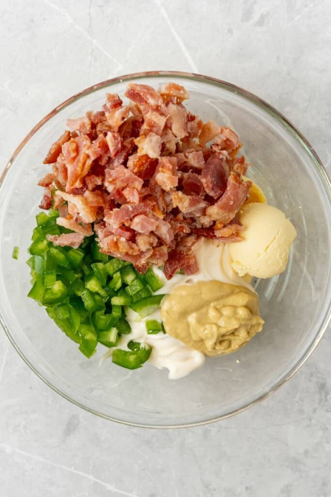 adding deviled egg filling in one bowl. 