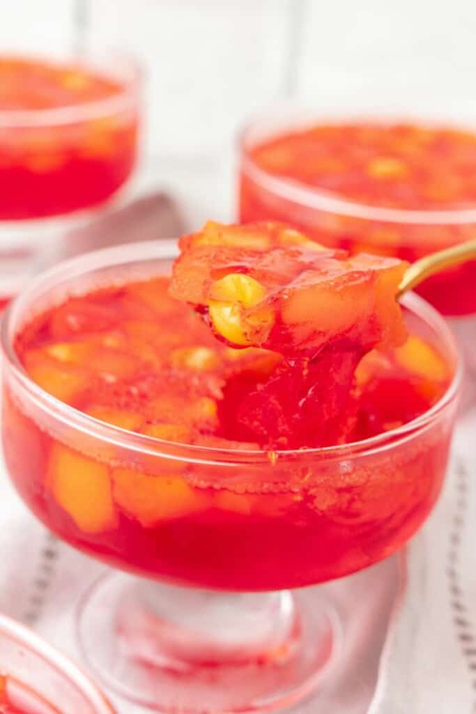 taking a bite out of jello with fruit. 