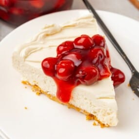 overhead shot of no bake cheesecake slice with cherry topping