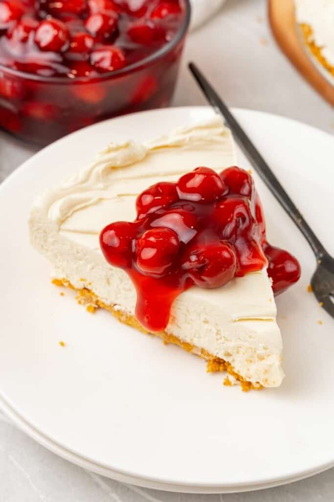 overhead shot of no bake cheesecake slice with cherry topping