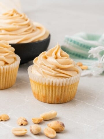 Close up shot of vanilla cake frosted with creamy peanut butter cream cheese icing.