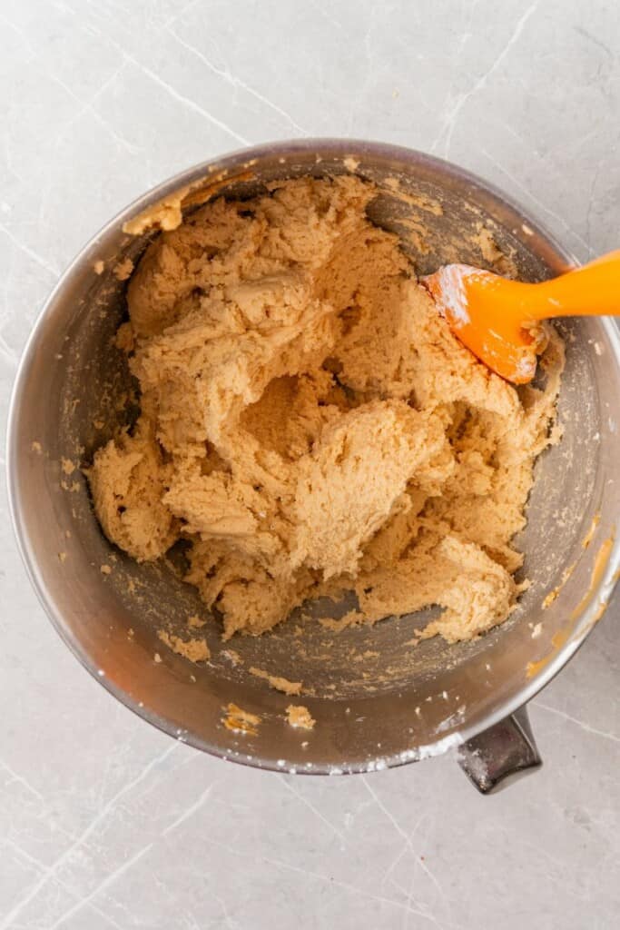 mixing ingredients to make creamy peanut frosting. 