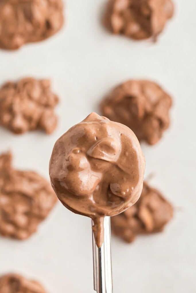 scooping melted chocolate peanuts with cookie scooper