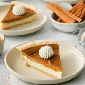 a slice of sweet potato cream cheese pie with whipped cream.