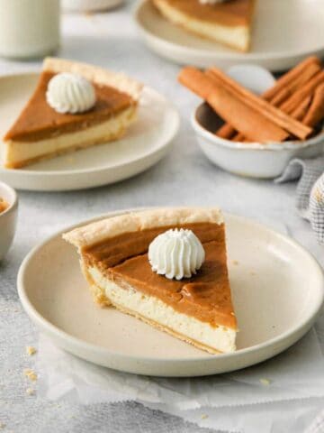 a slice of sweet potato cream cheese pie with whipped cream.