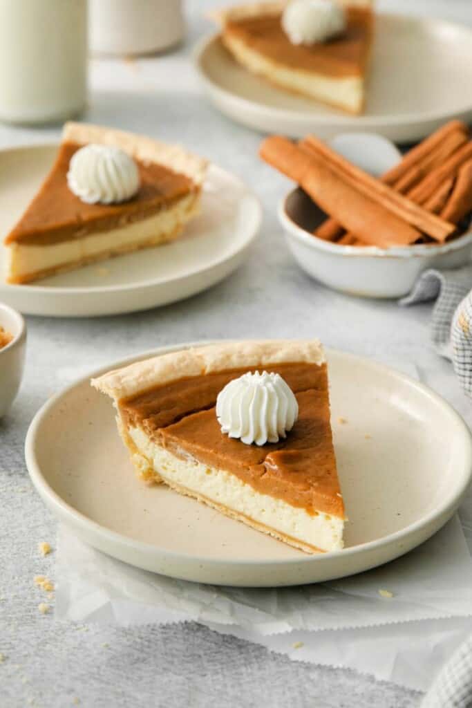 a slice of sweet potato cream cheese pie with whipped cream. 