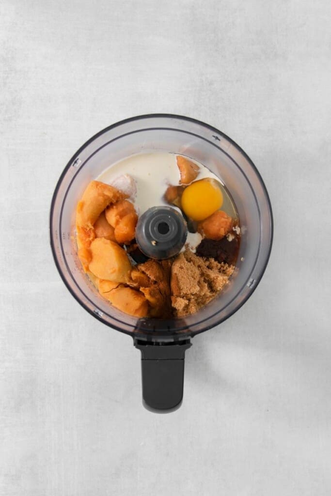 Adding sweet yams and eggs to food processor. 
