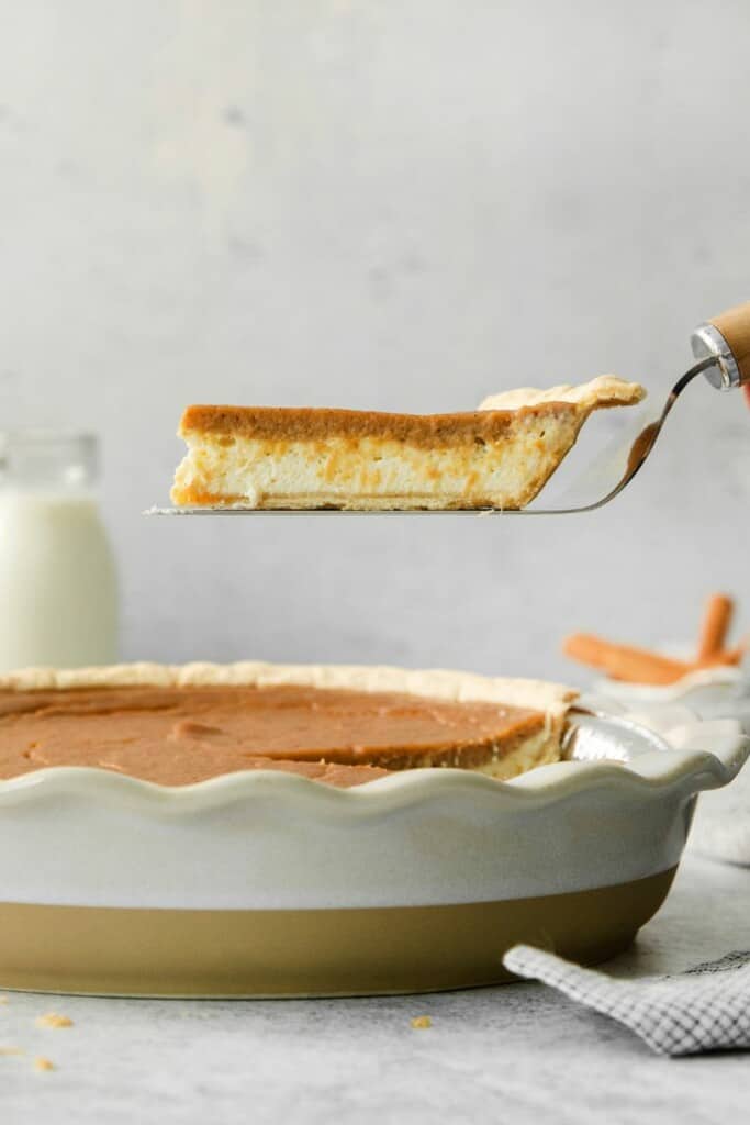 cutting a slice of sweet potato pie with cream cheese. 