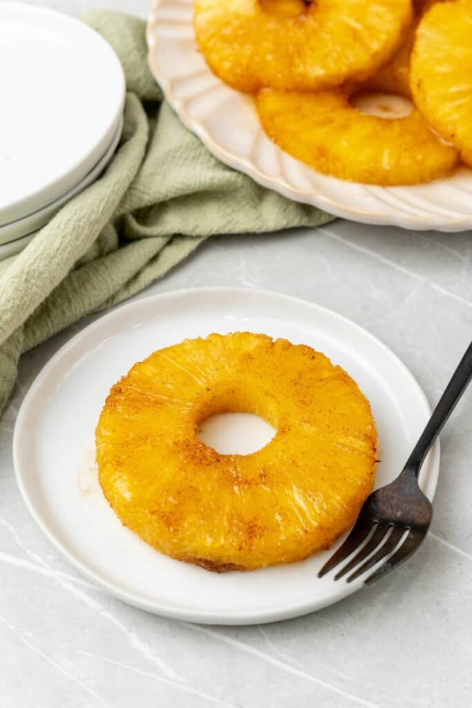 cinnamon roasted pineapple ring on a white plate 