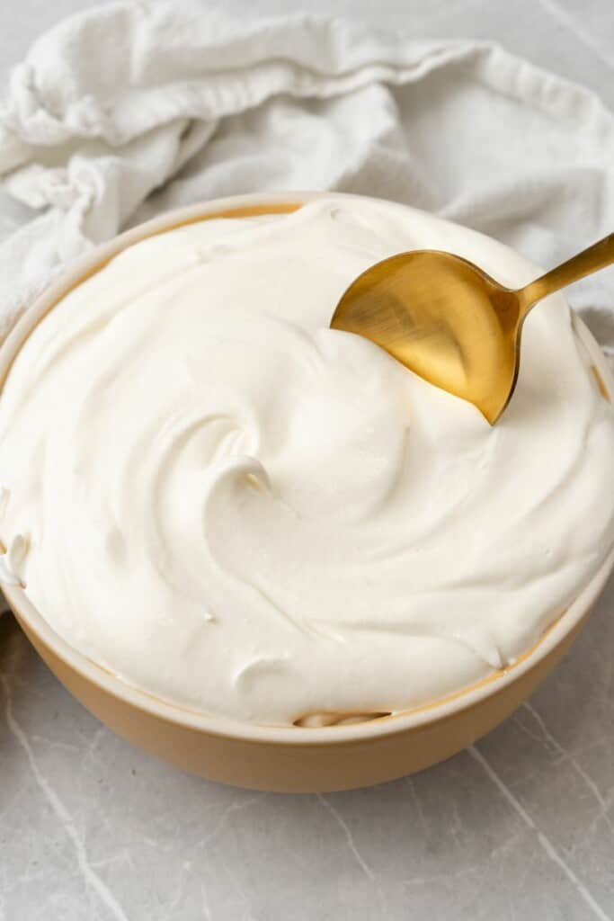 homemade whipped frosting with a gold spoon 