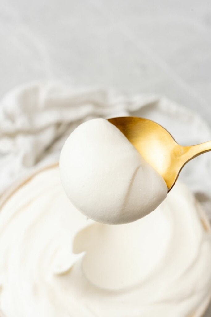 close up shot of a spoonful of cool whip frosting recipe 