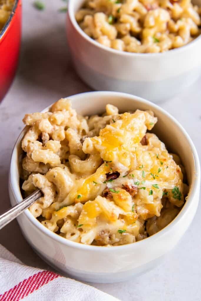 baked mac and cheese with cheddar and gruyere in a white bowl 