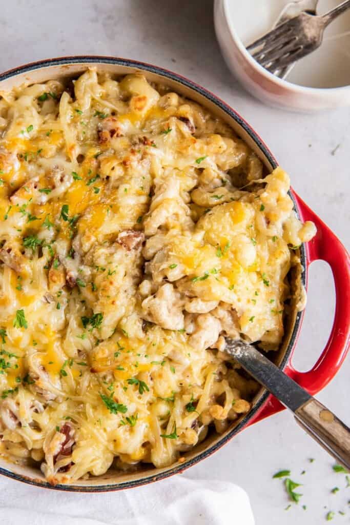 using a slotted spoon to serve homemade mac and cheese 