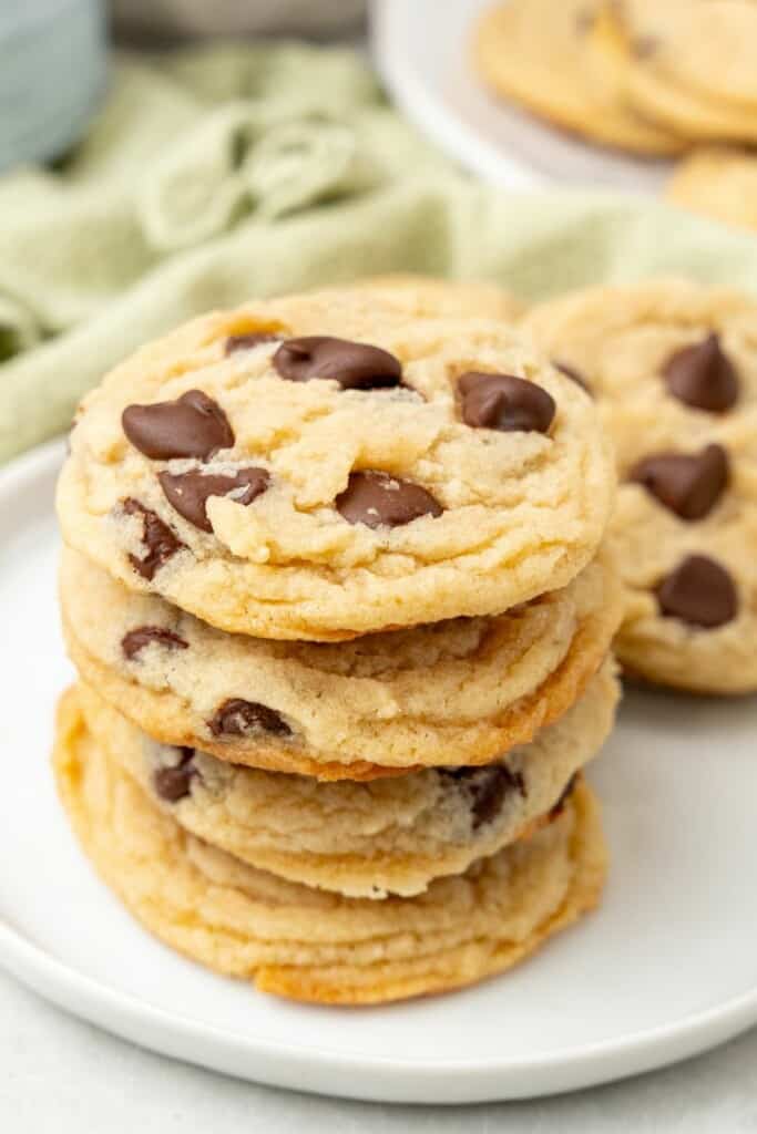 stacked no egg chocolate chip cookies on a white plate