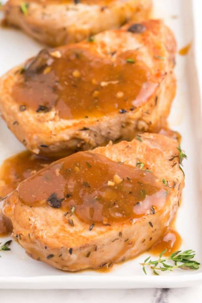 close up of thin pork loin chop with gravy 