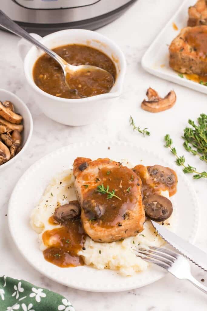 boneless pork chops with gravy over mashed potatoes