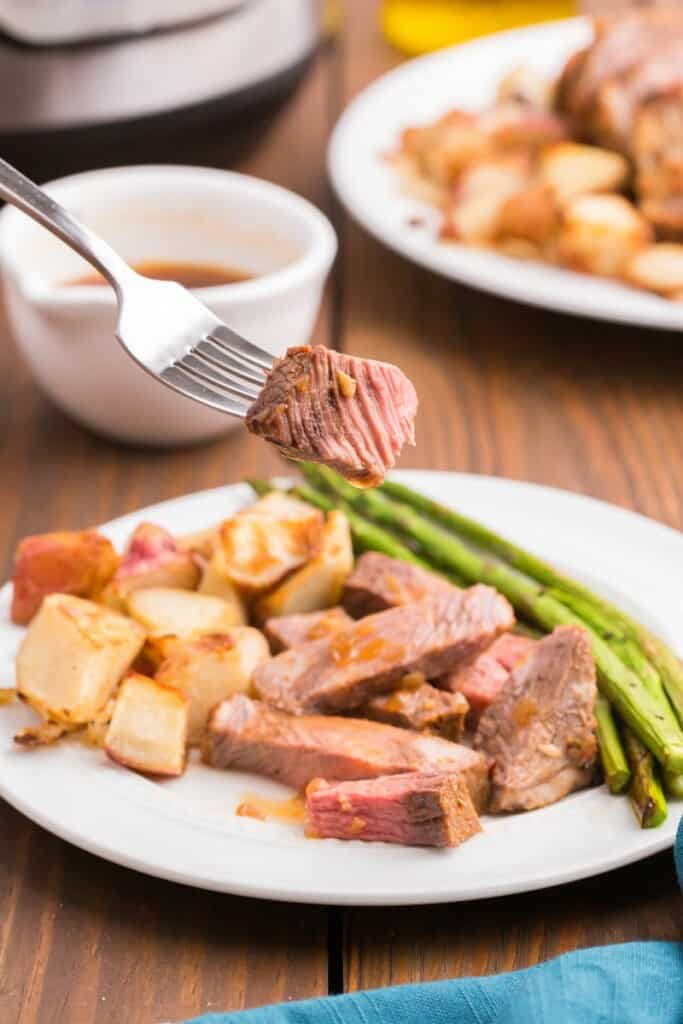 taking a bite of out meat roast with a fork 