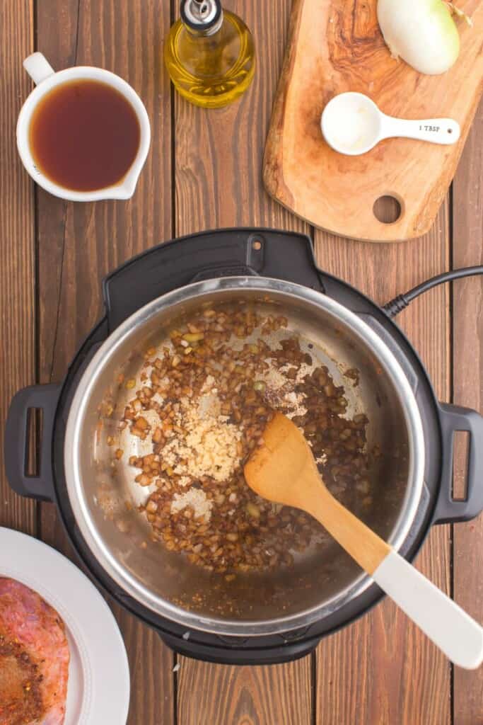 saute onions and garlic in hot instant pot 