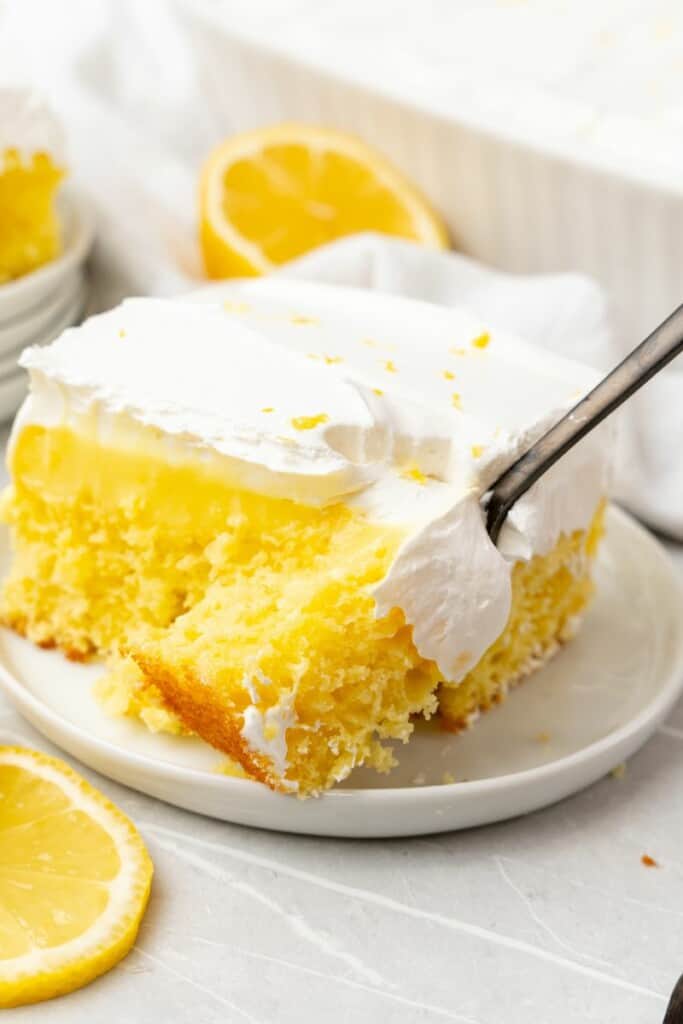 taking a bite out of lemon jello cake with a fork 