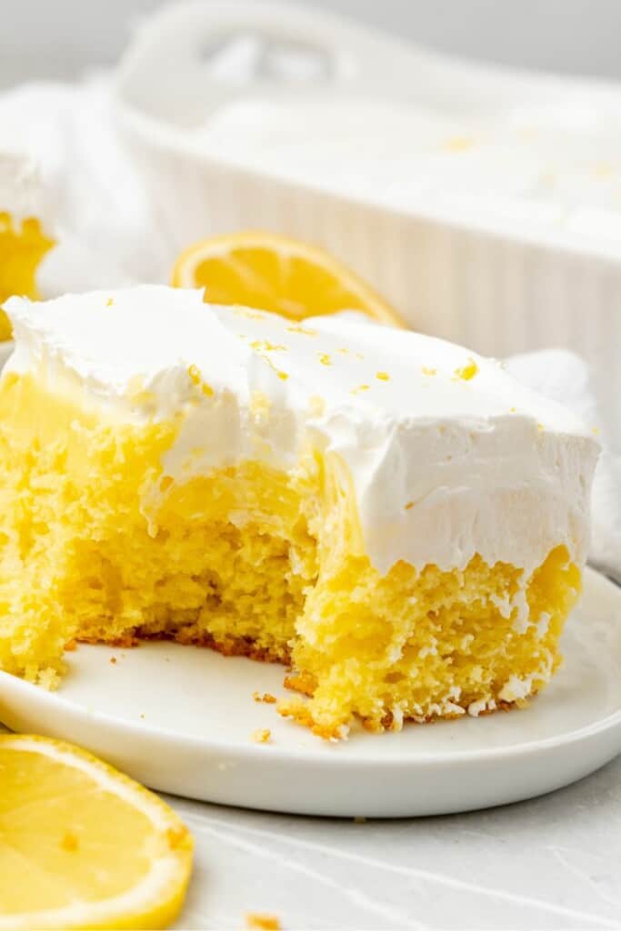 a piece of lemon pudding poke cake on a plate 