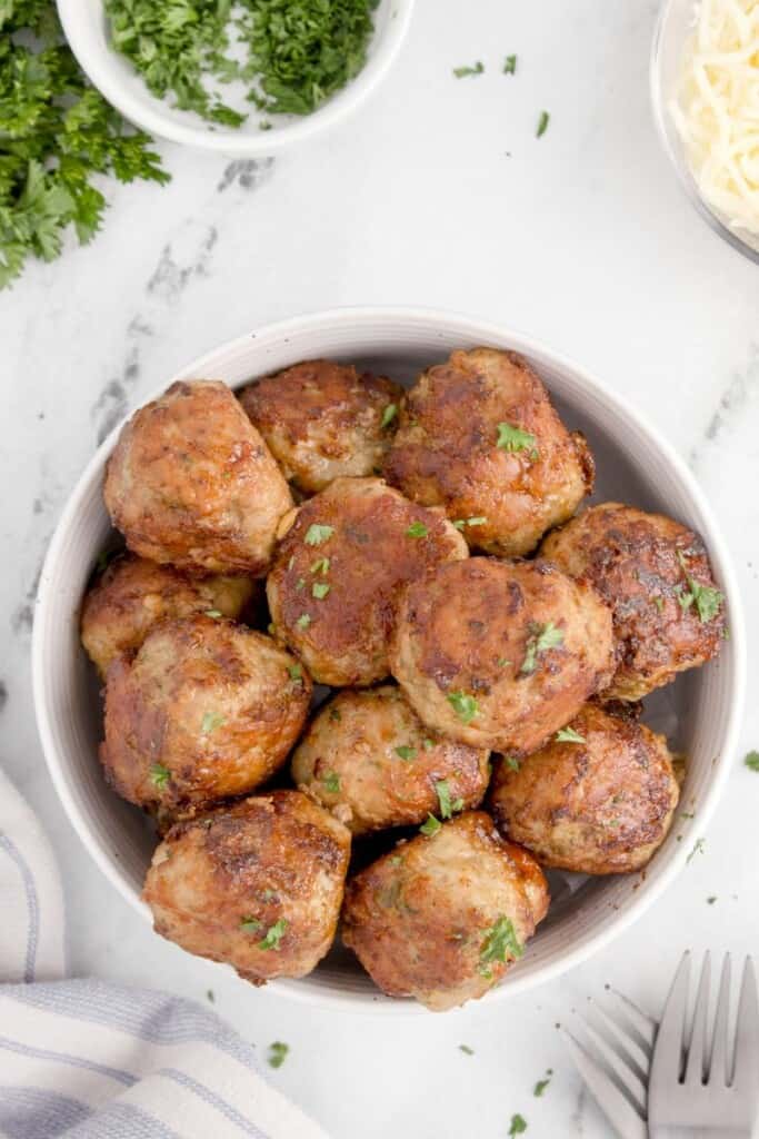 overhead shot of meatballs without breadcrumbs in a white bowl 