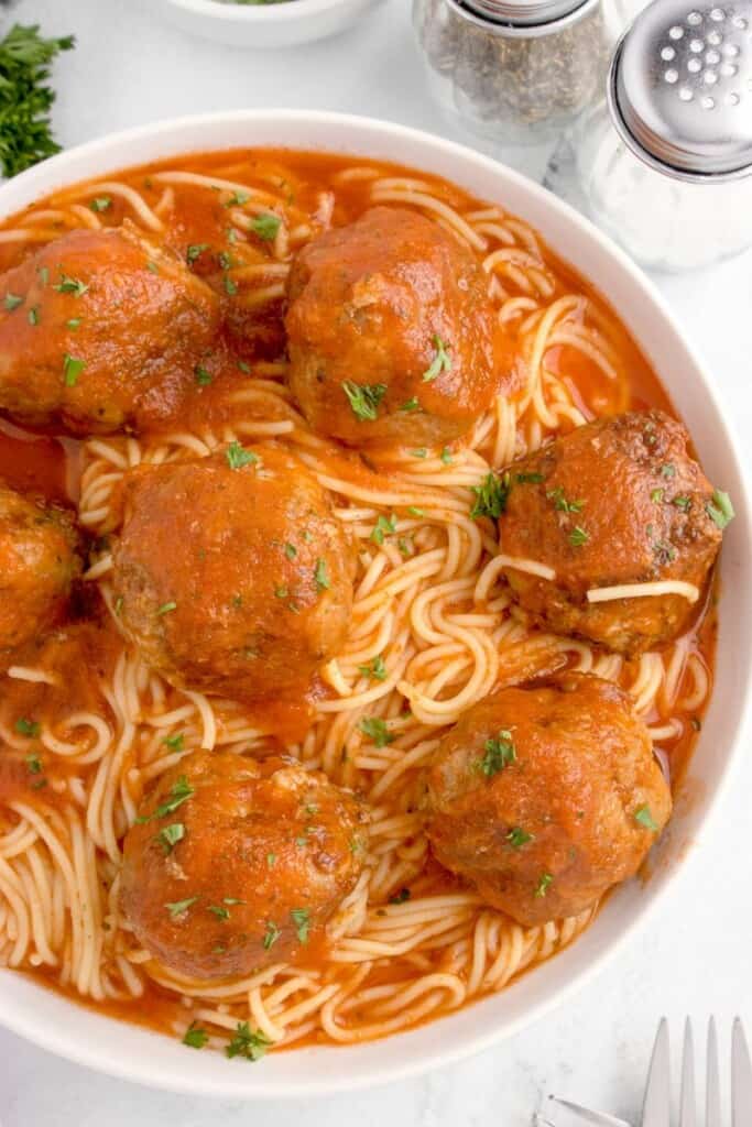 overhead shot of spaghetti with meatballs in a bowl 