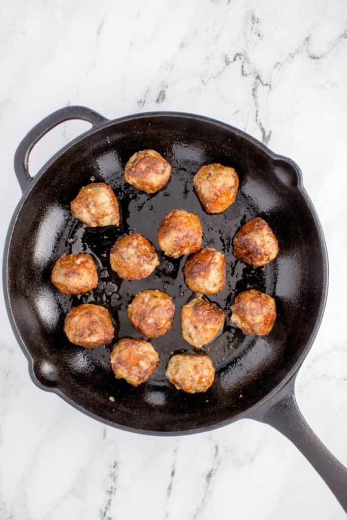seared beef meatballs in a pan 