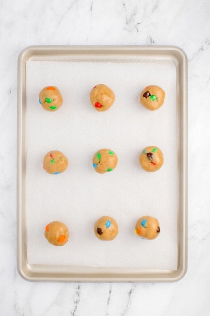 adding rolled cookie dough onto baking sheet